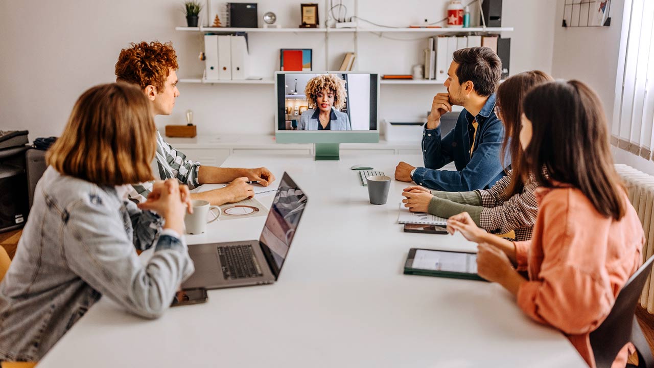 Team members in a hybrid work meeting